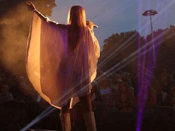 Singer performing in front of a crowd at Fontwell Park Racecourse.