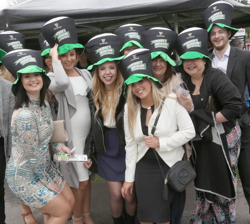 A large group of friends in matching guinness hats at Fontwell Races