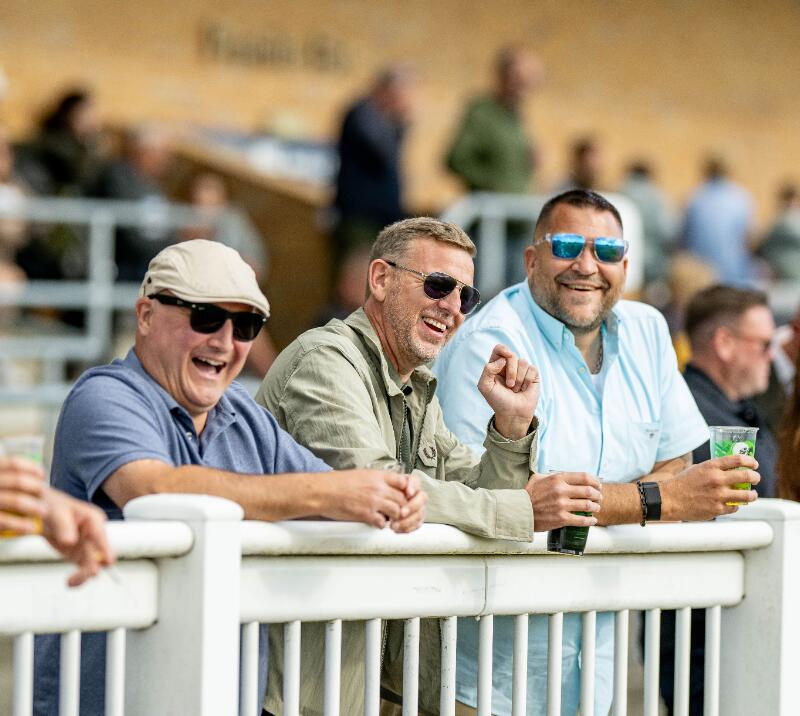 A group of gents laugh at the trackside at Fontwell Park