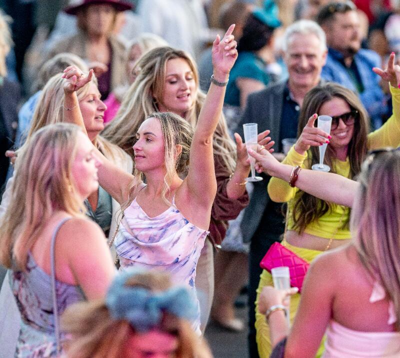 Race goers throwing out dance moves to live entertainment at Fontwell