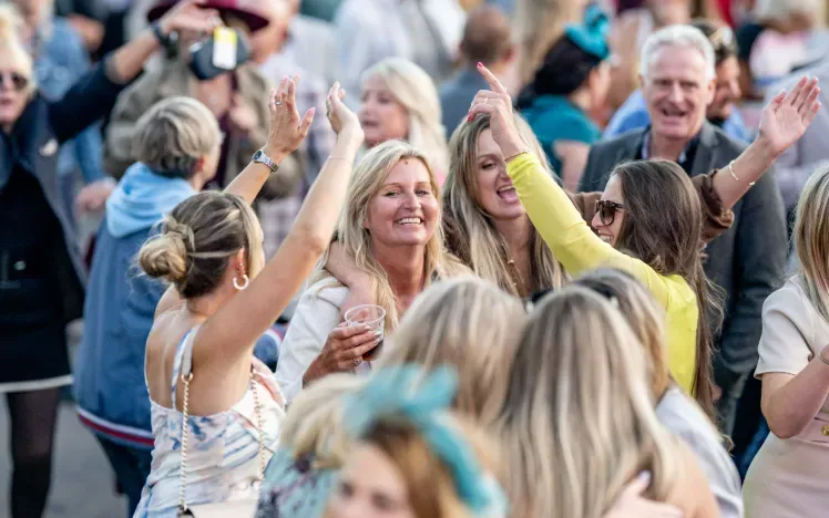 A group of women dance to the live music entertainment at Fontwell Park