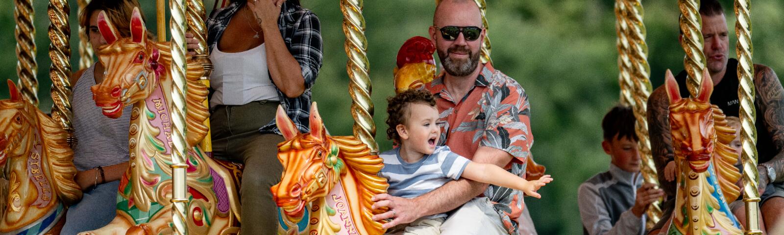 A father and son on the carousel at Fontwell Park