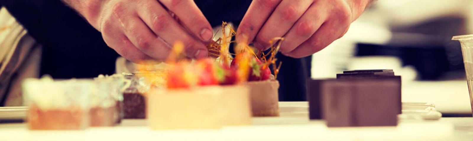 Close up on dessert being dressed up by a waiter.