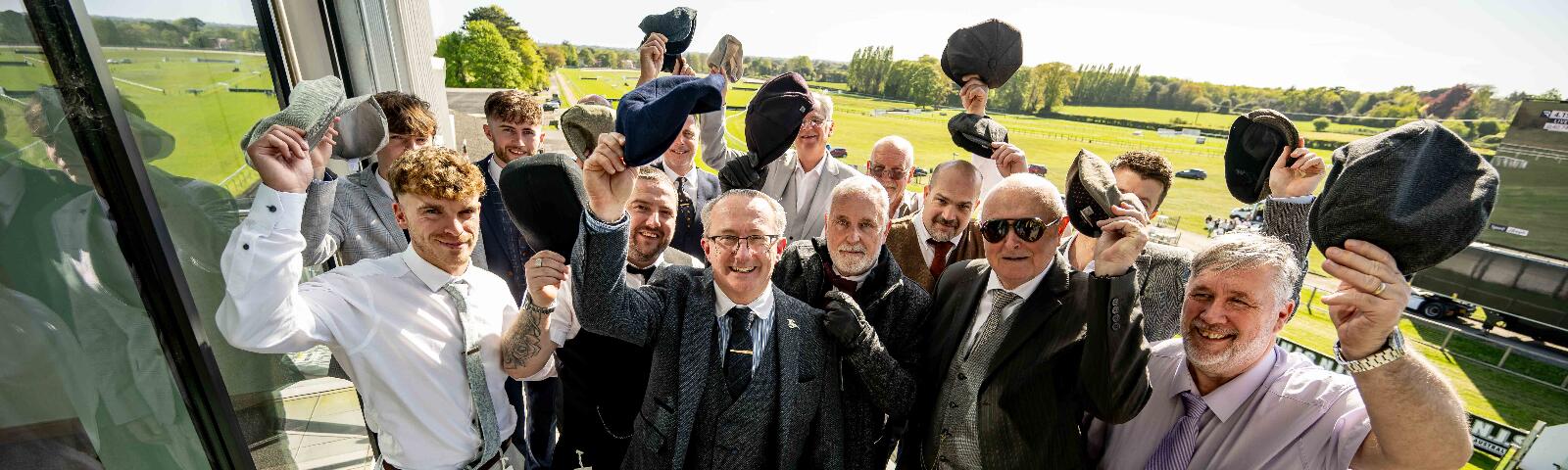 Racegoers cheering.
