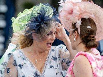 Ladies in fascinators sharing a laugh at Fontwell Park