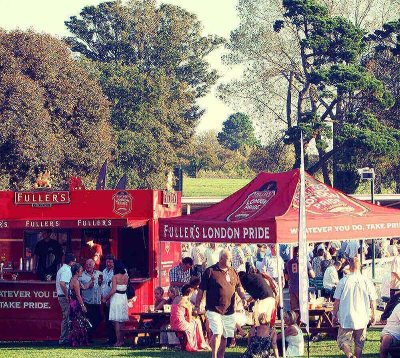 A view of Racegoers making the most of the sponsored outdoor refreshment options.