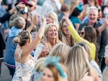 A group of women dance to the live music entertainment at Fontwell Park